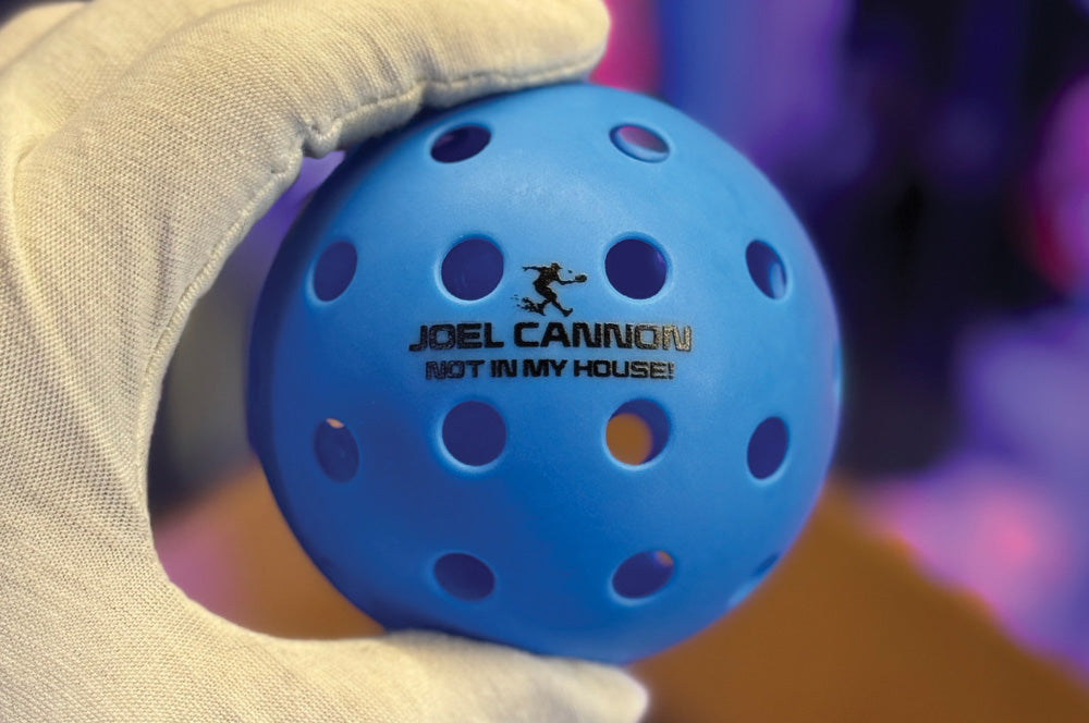 Blue pickleball with a personalized text print, great for team branding or gifts.