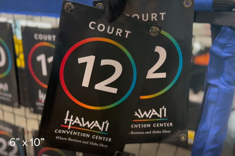 Custom court net signs for Hawaii Convention Center, featuring 6x10 inch black vinyl banners with colorful numbered circles and snap-on grommets