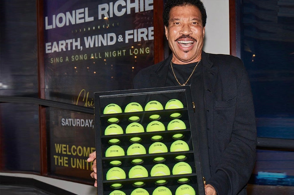Custom tennis ball gift set presented to Lionel Richie, perfect for celebrity events.