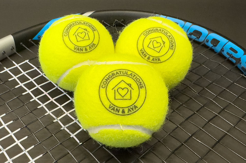Custom real estate agent tennis ball gift with a personalized design.