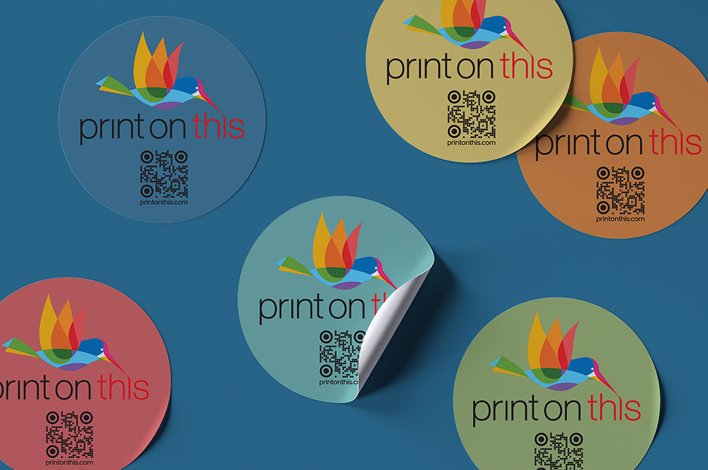 Round custom logo stickers with a peel-off effect, displayed on a blue background.