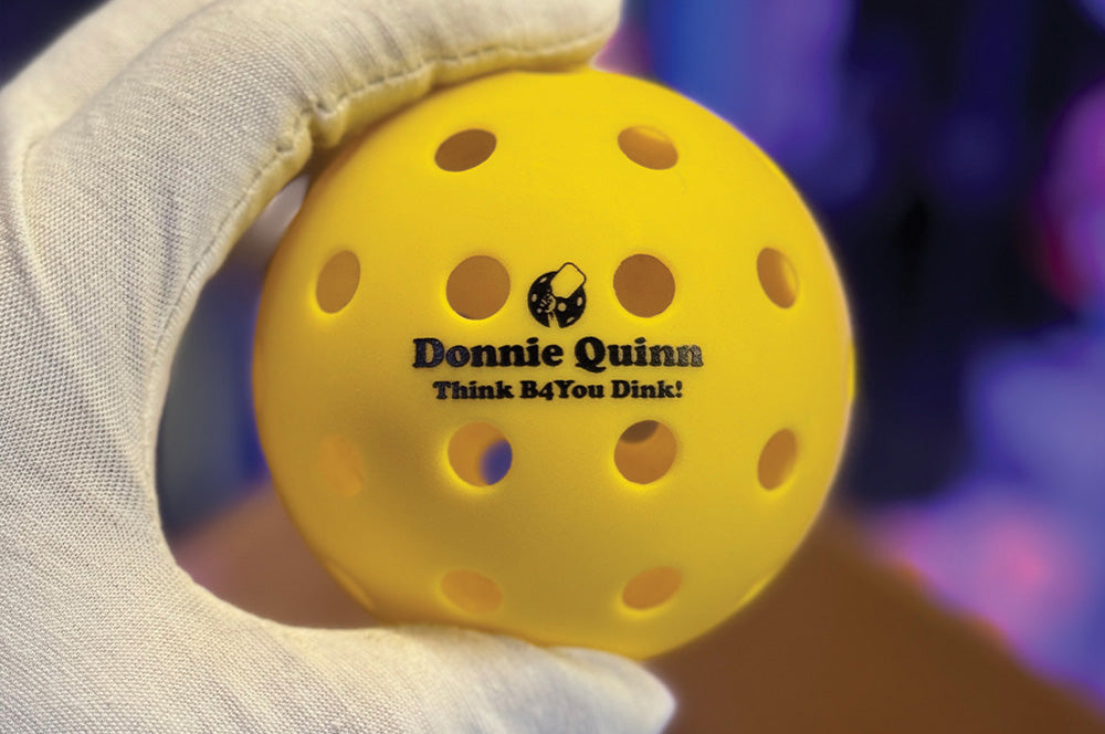Yellow pickleball featuring a custom text print for personalized play.